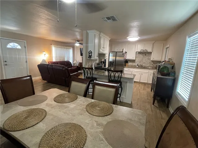 a kitchen with a sink and wooden floor
