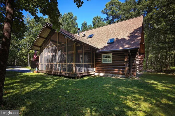 a view of a house with a yard and sitting area
