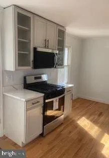 a kitchen with a stove and a microwave