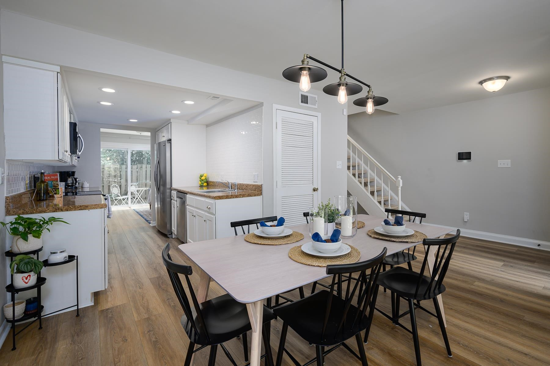 1714 Quail Ridge Road Raleigh, NC 27609 - Photo 7 of 25 a view of a dining room and livingroom with furniture wooden floor a chandelier