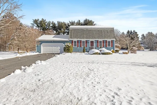 a view of a house with snow on the road