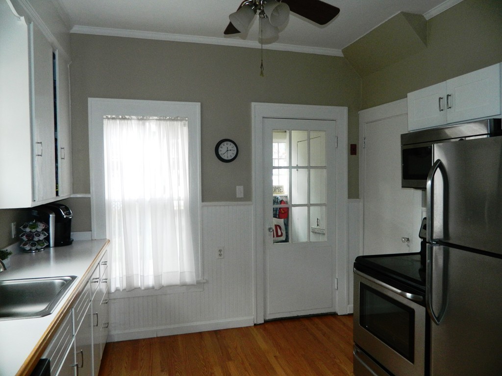 24 Birch Street Marblehead, MA 01945 - Photo 11 of 19 a kitchen with granite countertop a refrigerator stove and sink