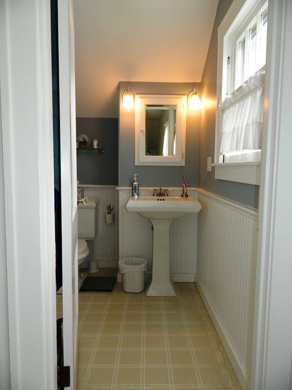 24 Birch Street Marblehead, MA 01945 - Photo 12 of 19 a bathroom with a sink toilet and mirror