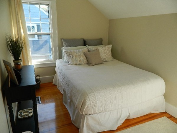 24 Birch Street Marblehead, MA 01945 - Photo 15 of 19 a bed sitting in a bedroom next to a window