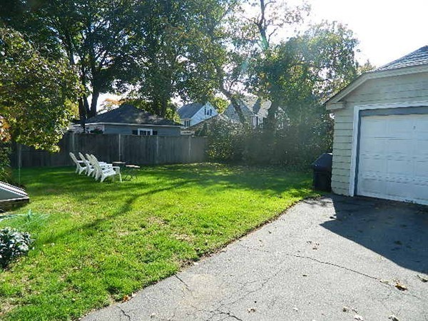 24 Birch Street Marblehead, MA 01945 - Photo 19 of 19 a view of a backyard with a small cabin and a chair
