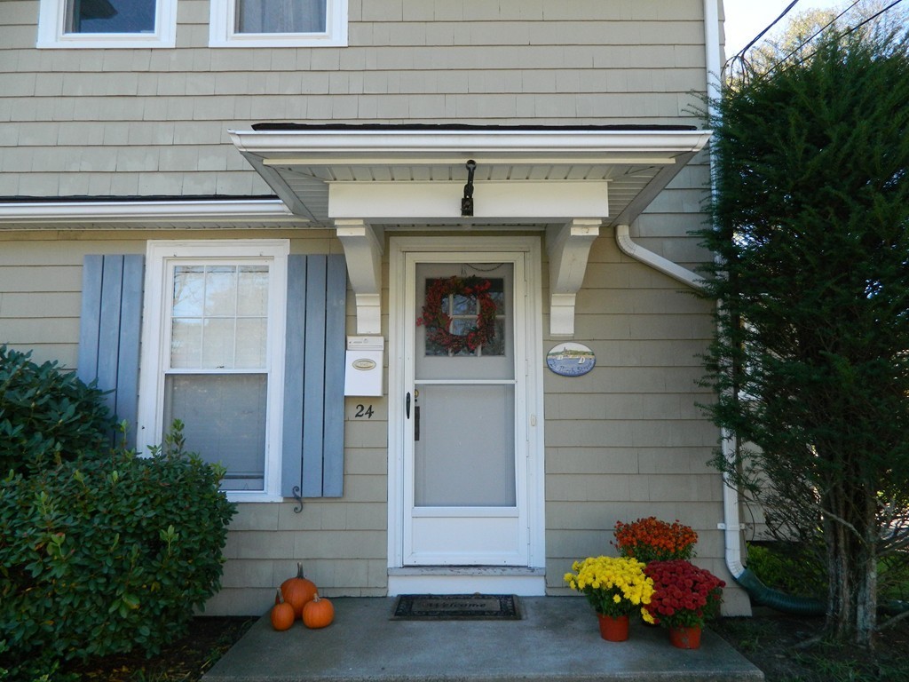 24 Birch Street Marblehead, MA 01945 - Photo 2 of 19 a front view of a house with a garden