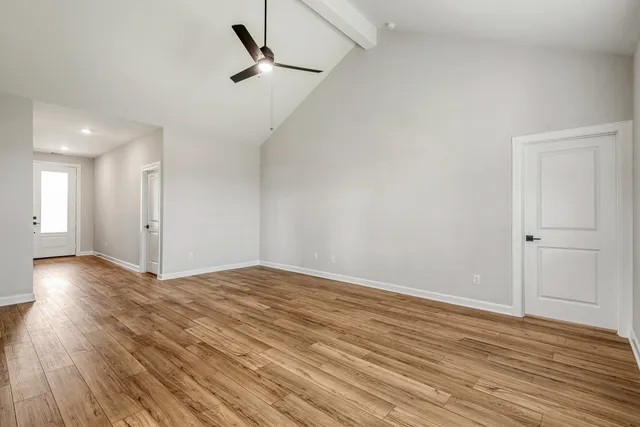 wooden floor in an empty room with a window
