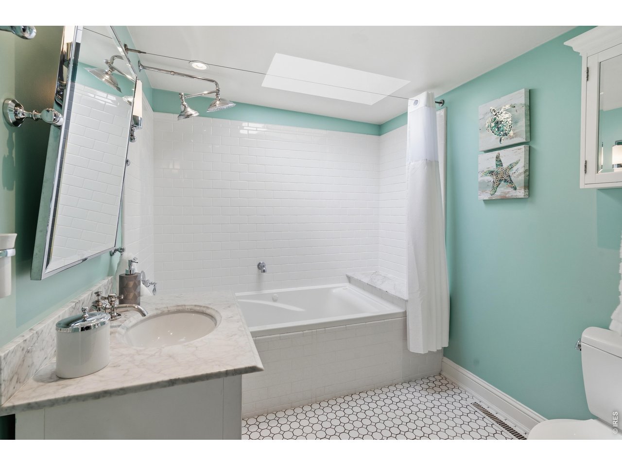 936 6th Street Berthoud, CO 80513 - Photo 14 of 22 a bathroom with a sink a toilet and a mirror