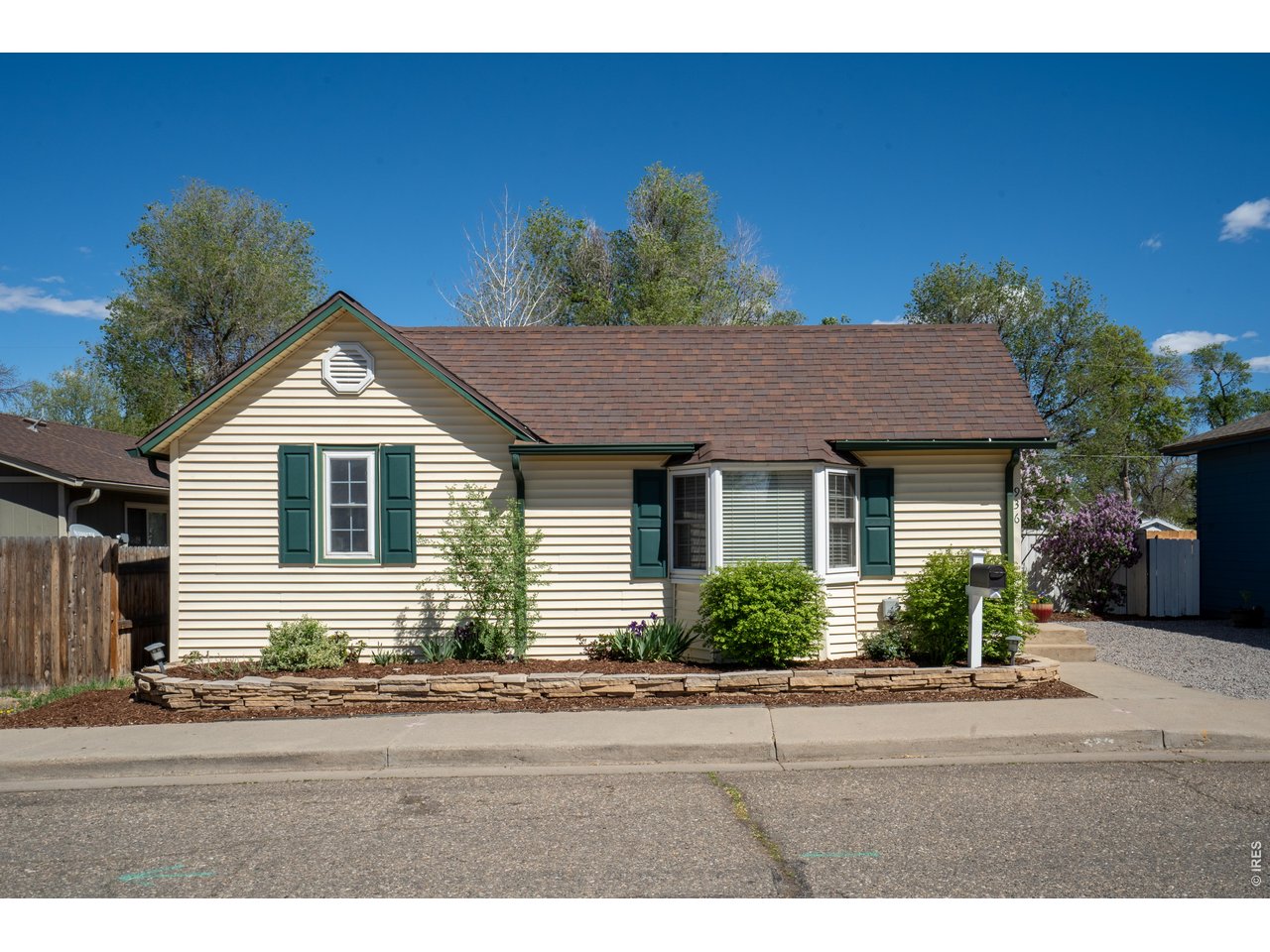 936 6th Street Berthoud, CO 80513 - Photo 2 of 22 a front view of a house with a yard
