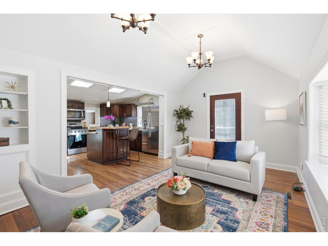 936 6th Street Berthoud, CO 80513 - Photo 7 of 22 a living room with furniture dining table and a chandelier