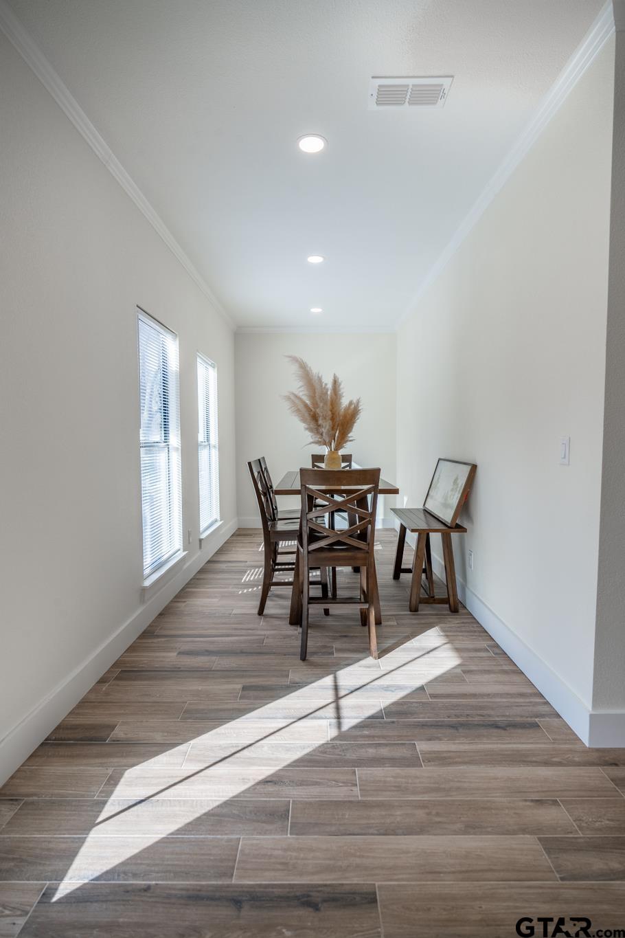 413 Stewart Street Lindale, TX 75771 - Photo 18 of 39 a dining room with furniture and wooden floor