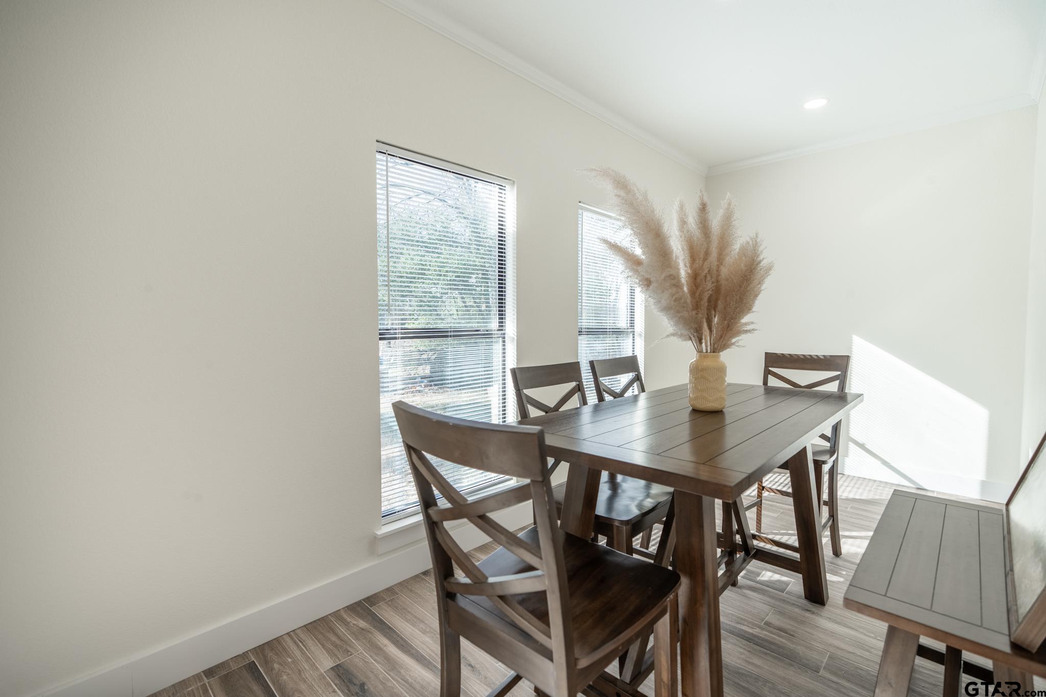 413 Stewart Street Lindale, TX 75771 - Photo 19 of 39 a view of a dining room with furniture and wooden floor