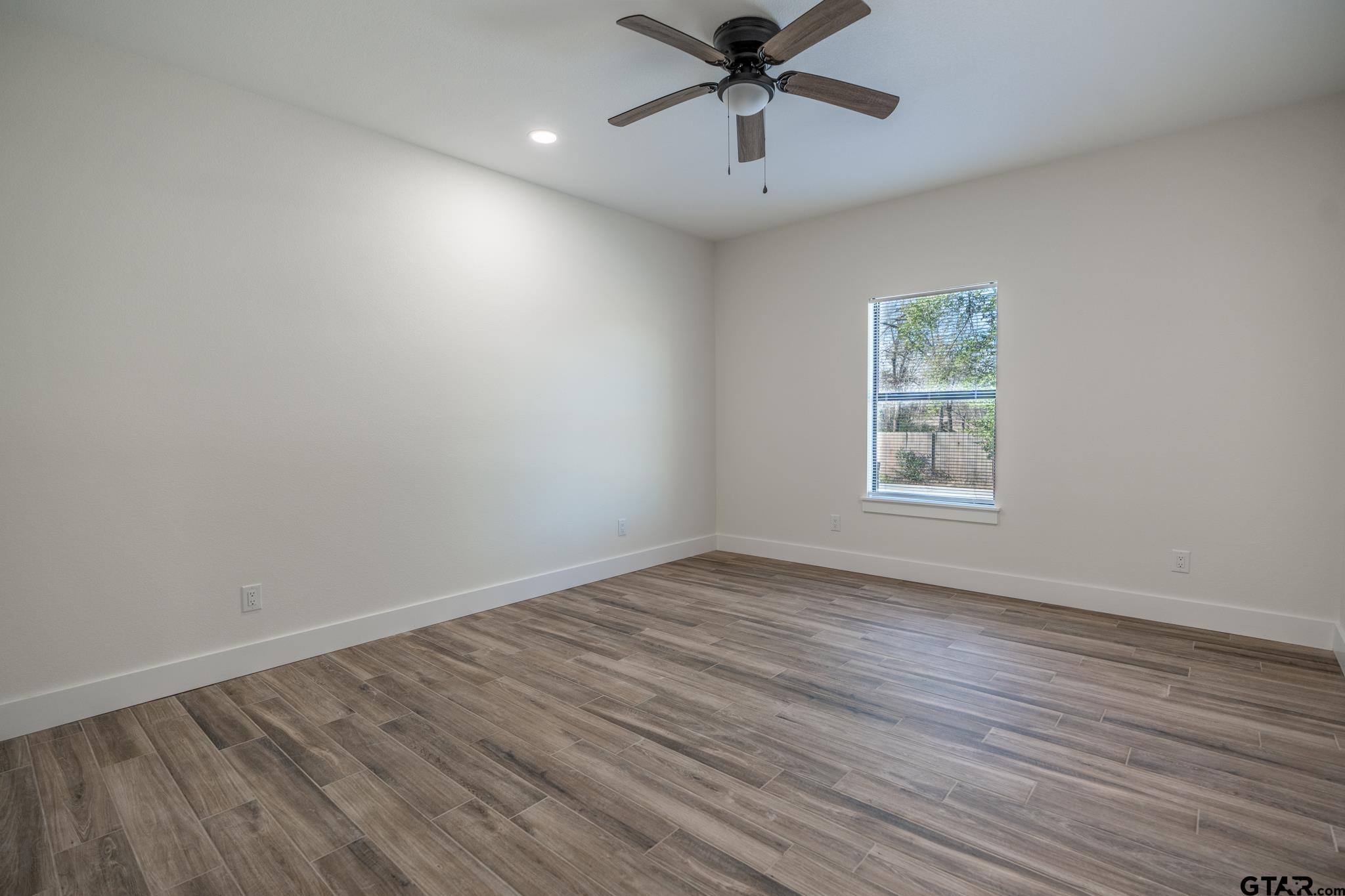 413 Stewart Street Lindale, TX 75771 - Photo 24 of 39 wooden floor in an empty room with a window