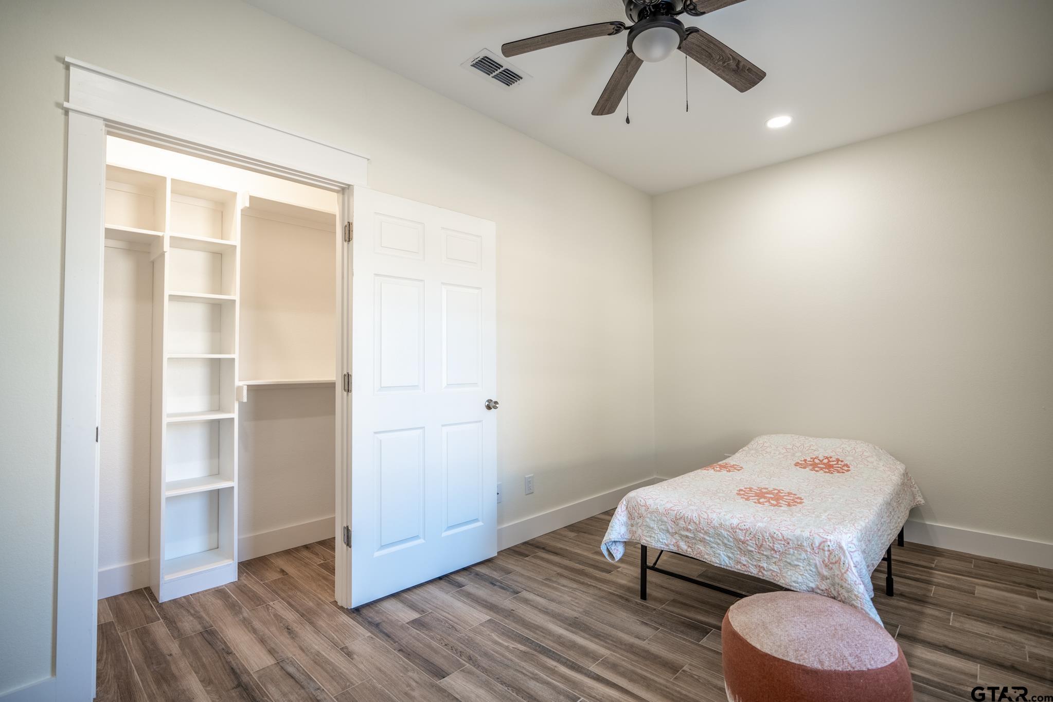 413 Stewart Street Lindale, TX 75771 - Photo 27 of 39 a bedroom with a bed and a ceiling fan