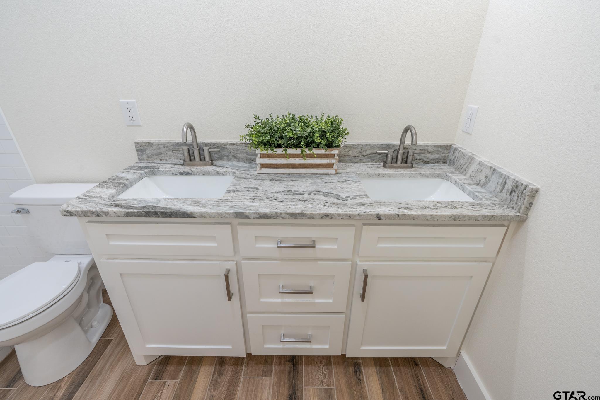 413 Stewart Street Lindale, TX 75771 - Photo 32 of 39 a bathroom with a granite countertop sink toilet and mirror