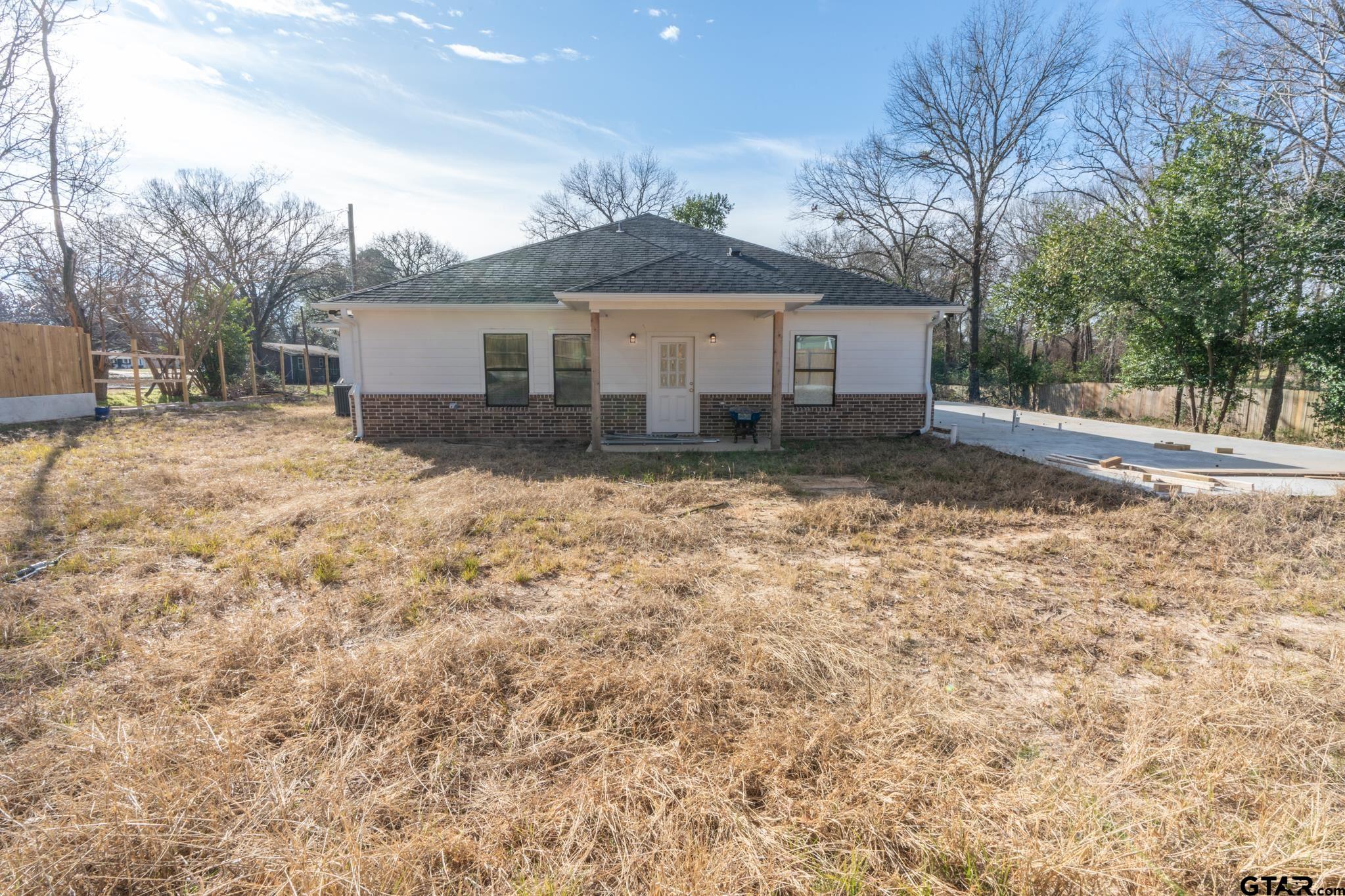 413 Stewart Street Lindale, TX 75771 - Photo 34 of 39 a view of a house with a yard