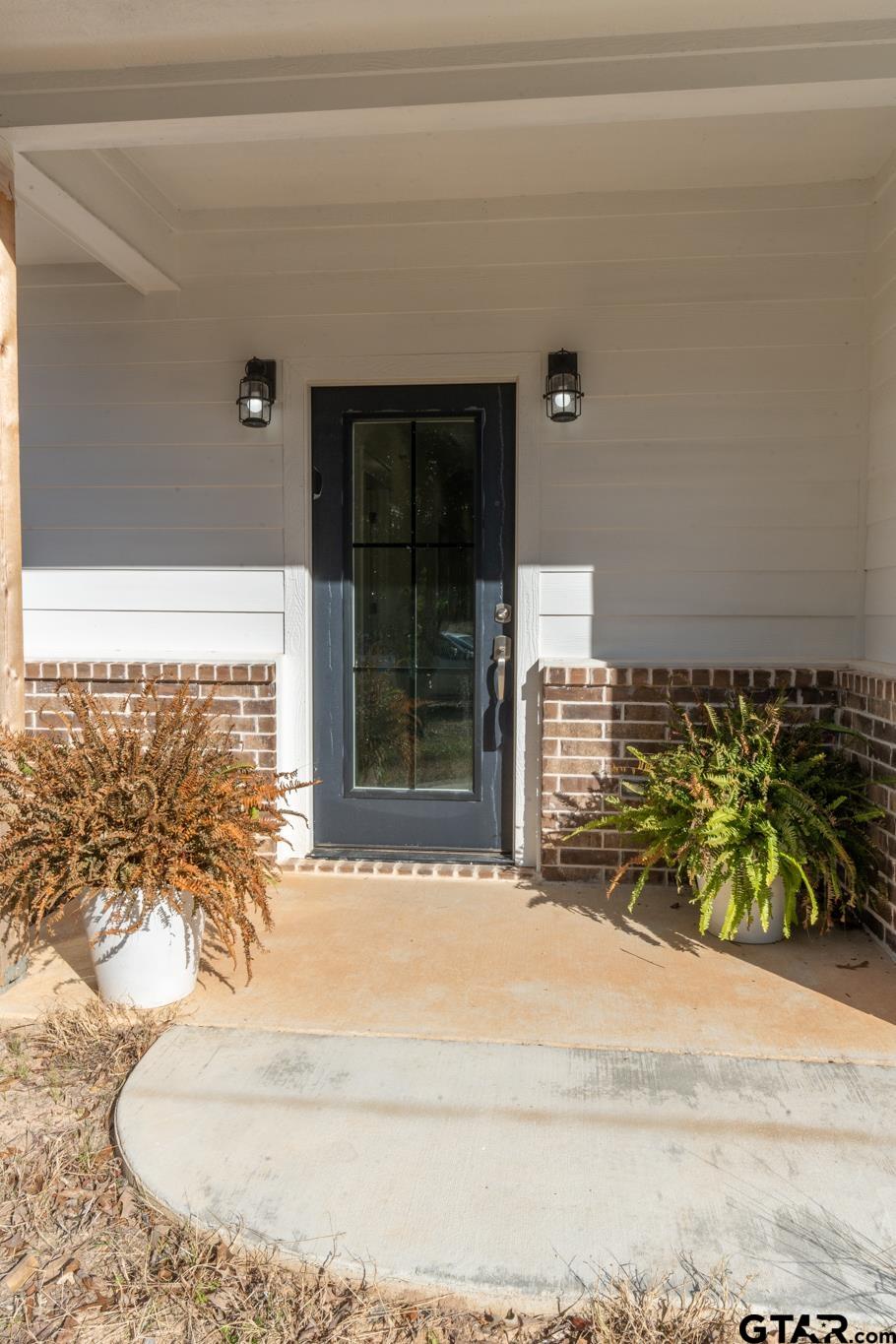 413 Stewart Street Lindale, TX 75771 - Photo 7 of 39 a view of a entryway door front of a house