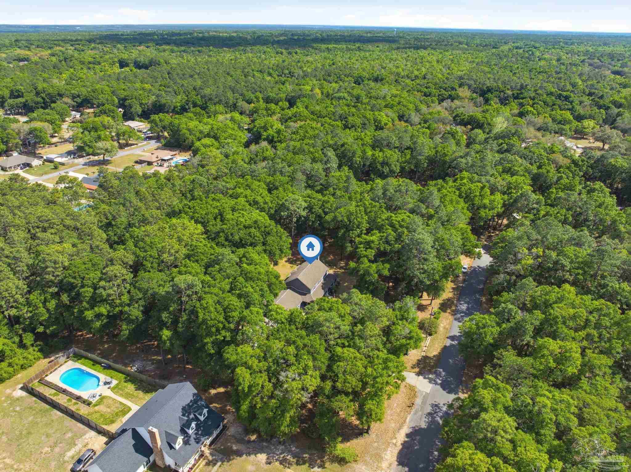 6930 Summit Way Milton, FL 32570 - Photo 68 of 71 a view of a house with a lush green forest