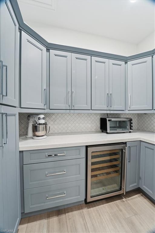 5130 Alpha Court Naples, FL 34105 - Photo 11 of 49 a kitchen with granite countertop white cabinets and white appliances