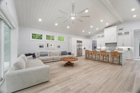 a living room with furniture and kitchen view