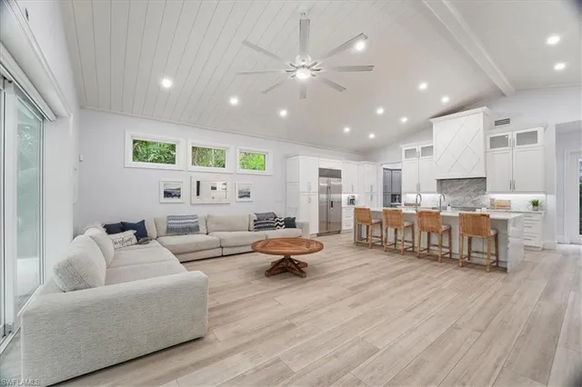 a living room with furniture and kitchen view