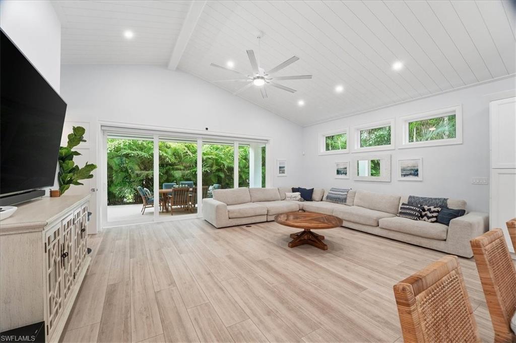5130 Alpha Court Naples, FL 34105 - Photo 13 of 49 a living room with furniture and a flat screen tv