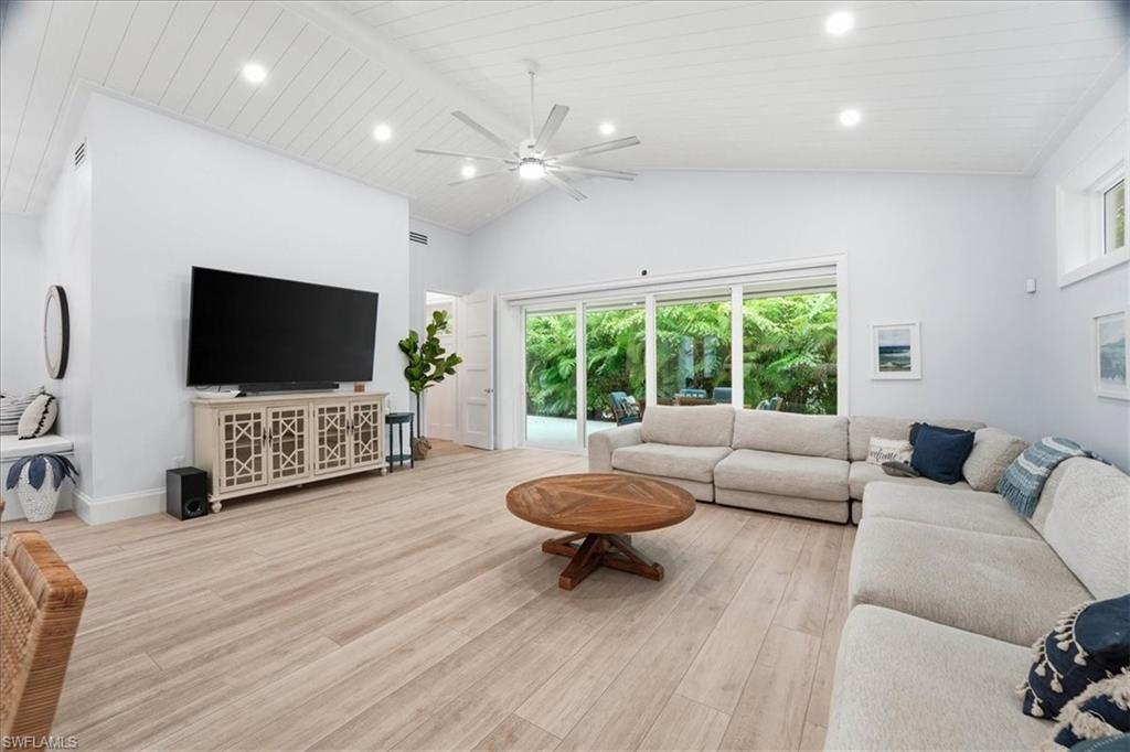 5130 Alpha Court Naples, FL 34105 - Photo 14 of 49 a living room with furniture and a flat screen tv