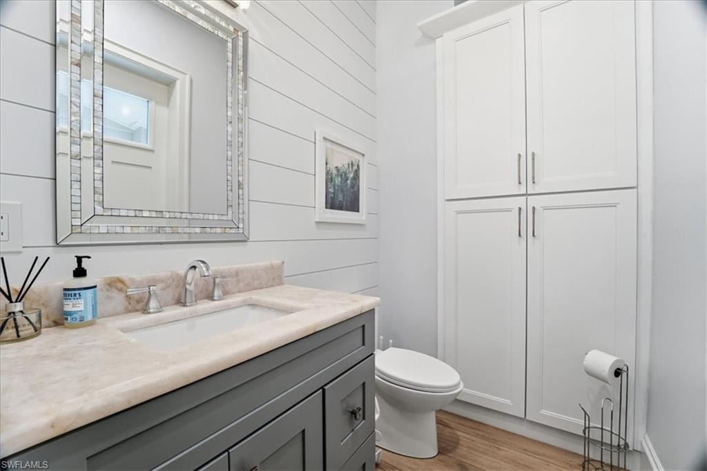 5130 Alpha Court Naples, FL 34105 - Photo 15 of 49 a bathroom with a granite countertop sink toilet and mirror