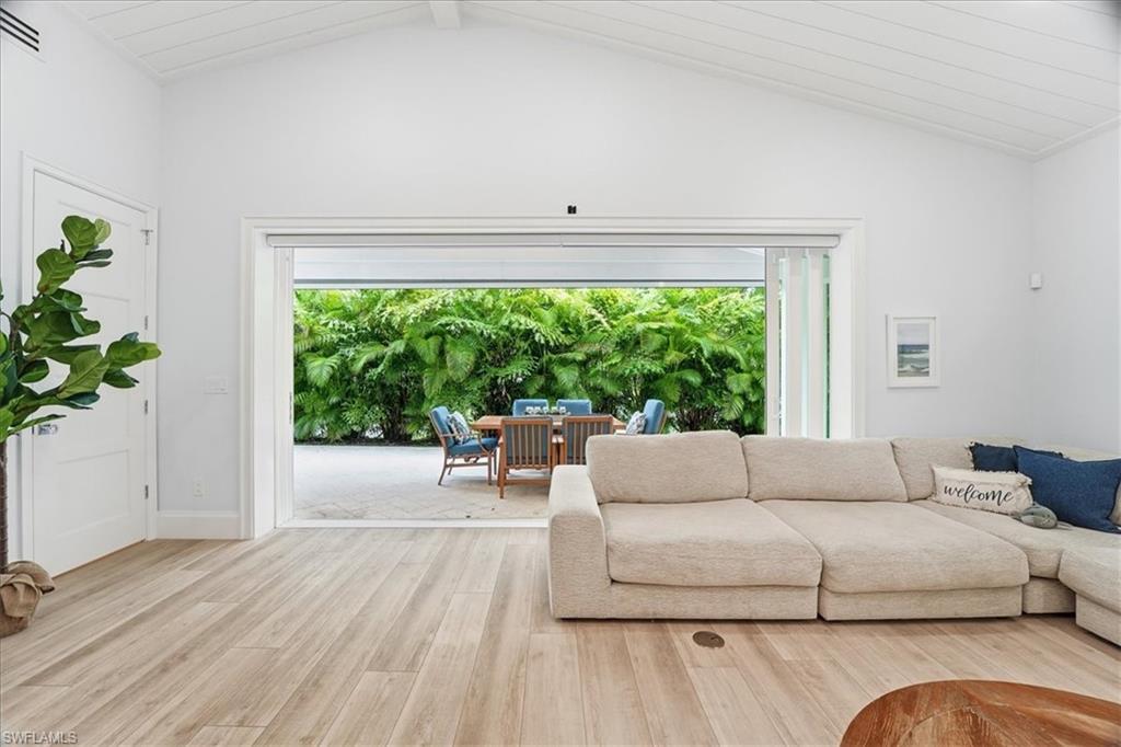 5130 Alpha Court Naples, FL 34105 - Photo 16 of 49 a living room with furniture and a large window