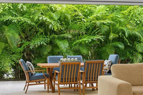 a view of a chairs and table in the patio