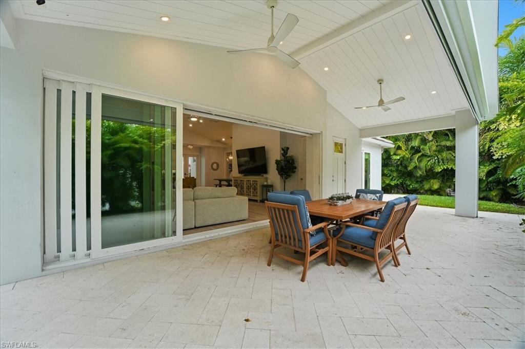 5130 Alpha Court Naples, FL 34105 - Photo 20 of 49 a dining room with furniture and a floor to ceiling window