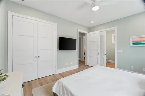 a bedroom with a bed and a flat screen tv