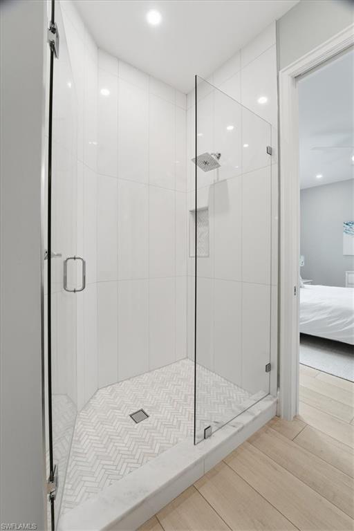 5130 Alpha Court Naples, FL 34105 - Photo 24 of 49 a bathroom with a glass shower door and a sink