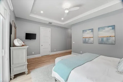 a bedroom with a bed and a flat screen tv