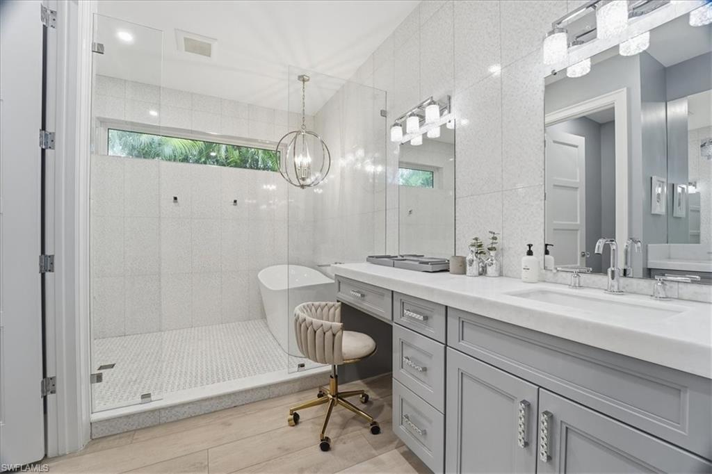 5130 Alpha Court Naples, FL 34105 - Photo 27 of 49 a bathroom with a sink mirror and a shower