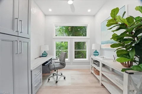 a view of a workspace with furniture and a potted plant