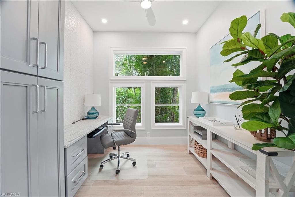 5130 Alpha Court Naples, FL 34105 - Photo 30 of 49 a view of a workspace with furniture and a potted plant