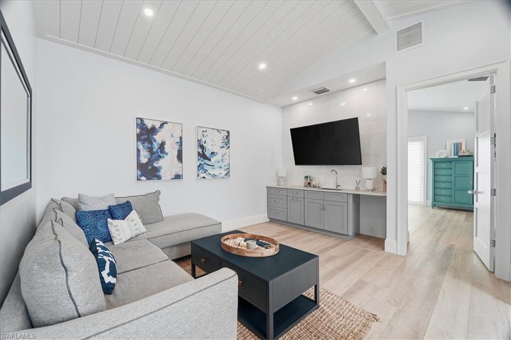 5130 Alpha Court Naples, FL 34105 - Photo 36 of 49 a living room with furniture and a flat screen tv