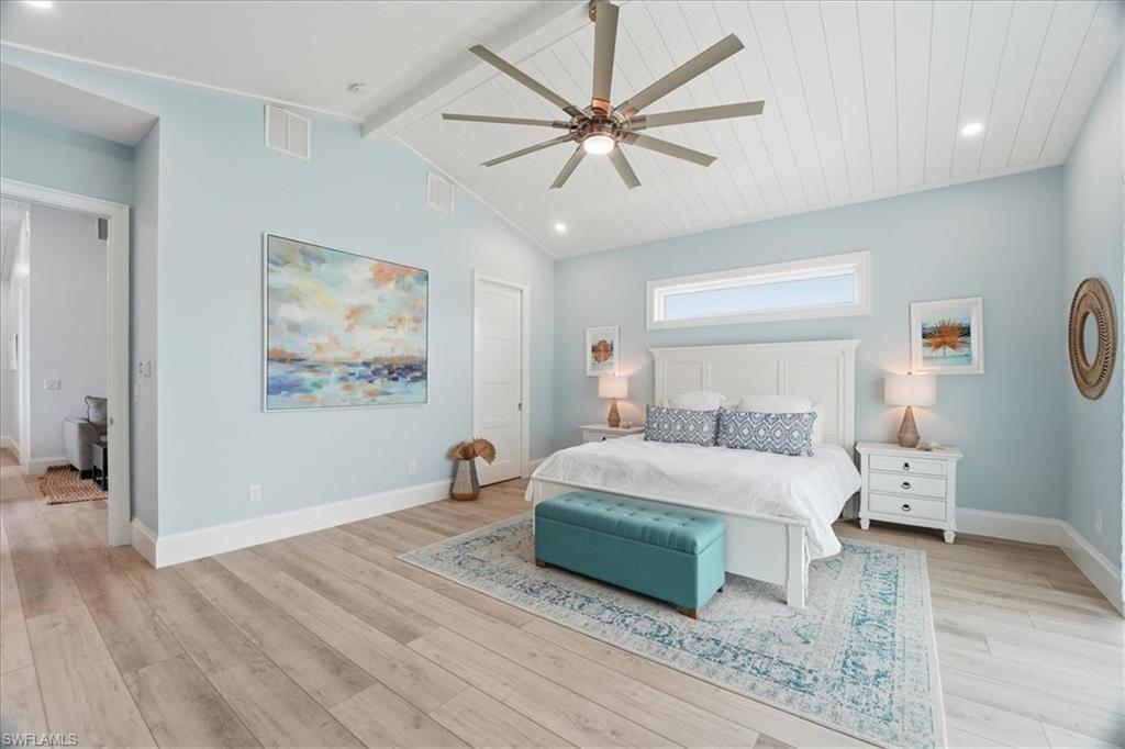 5130 Alpha Court Naples, FL 34105 - Photo 38 of 49 a bedroom with a bed and a chandelier