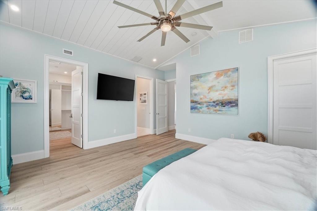 5130 Alpha Court Naples, FL 34105 - Photo 39 of 49 a bedroom with a bed and a flat screen tv