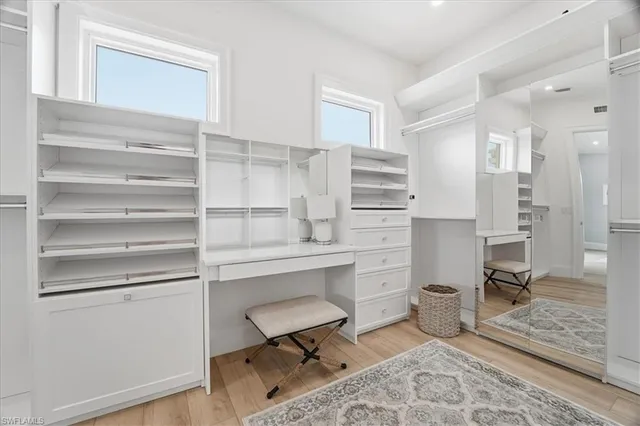 a spacious bathroom with a bathtub sink mirror double vanity and a bathtub