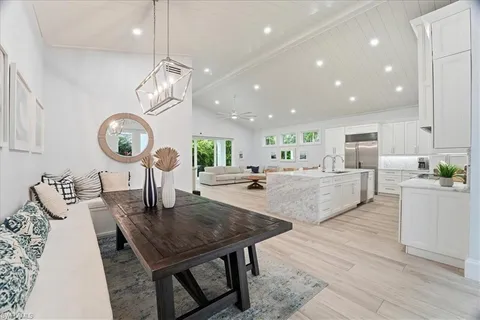 a large kitchen with a table and chairs
