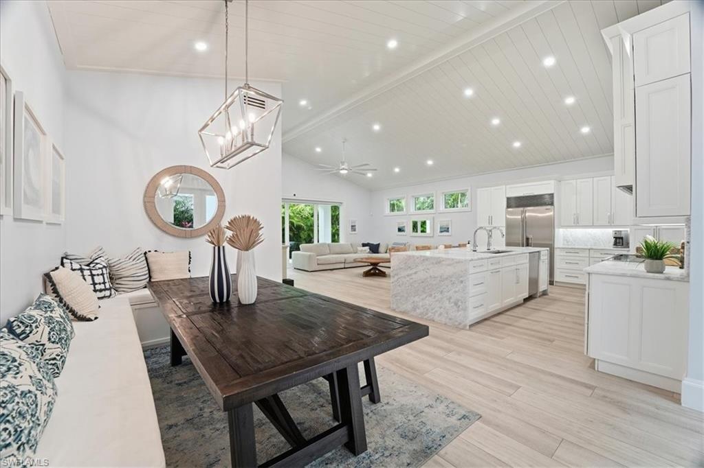 5130 Alpha Court Naples, FL 34105 - Photo 4 of 49 a large kitchen with a table and chairs