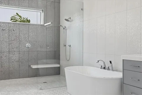 a bathroom with a double vanity sink toilet and shower