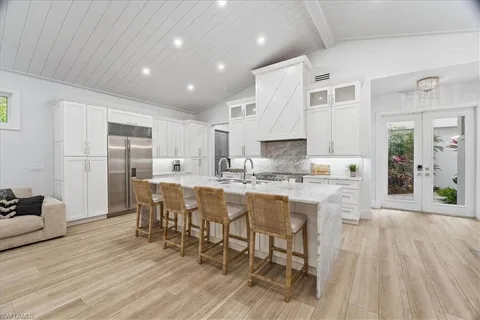 a large kitchen with lots of counter space and furniture