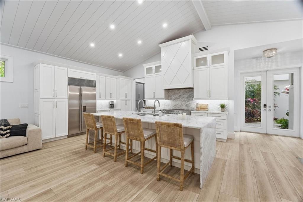 5130 Alpha Court Naples, FL 34105 - Photo 5 of 49 a large kitchen with lots of counter space and furniture