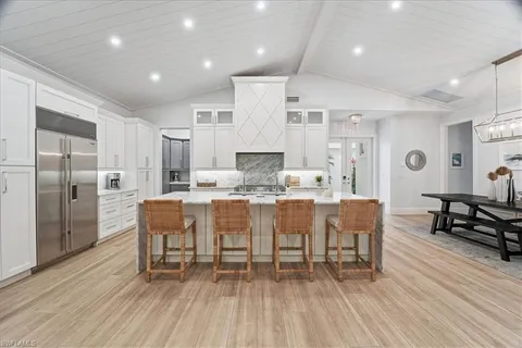 a large kitchen with a table and chairs