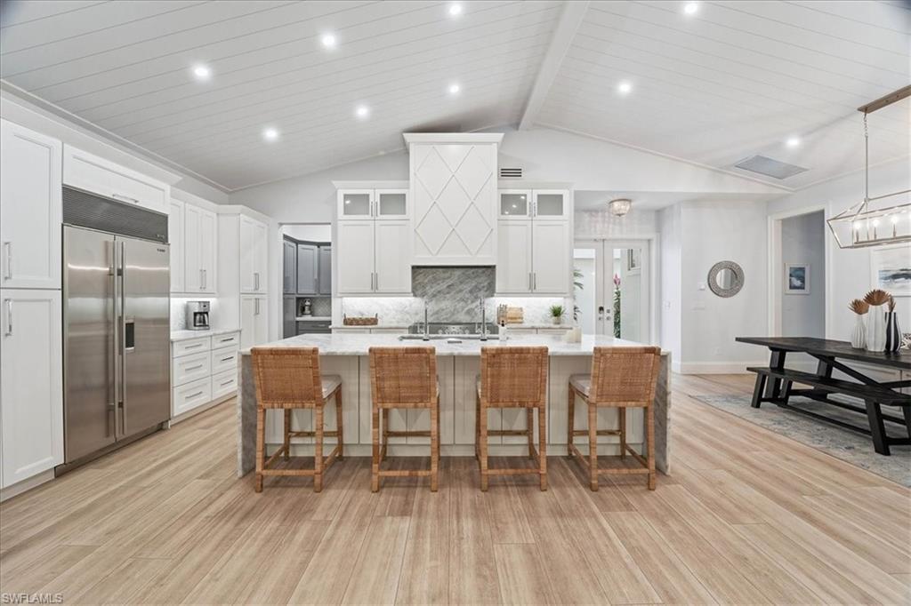 5130 Alpha Court Naples, FL 34105 - Photo 6 of 49 a large kitchen with a table and chairs