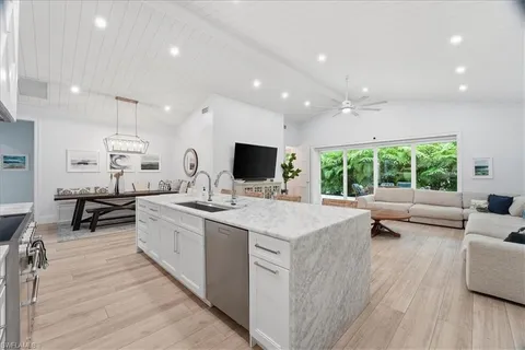 a large white kitchen with a large window