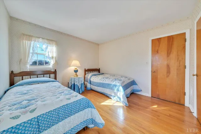 a bedroom with two beds and a window